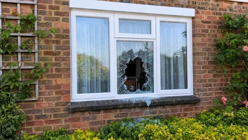 Before and after AI image of a smashed window used for a prank